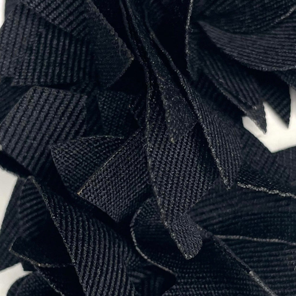 Black floral headpiece on a mannequin head with a white background